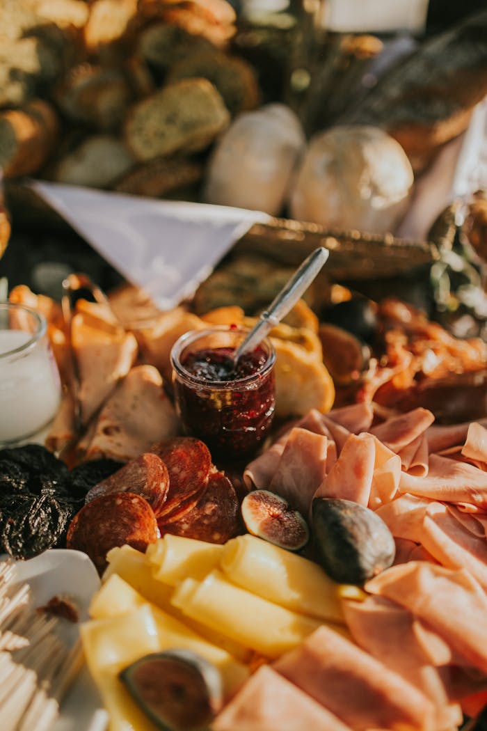 An indulgent charcuterie board featuring a variety of meats, cheeses, and jams.