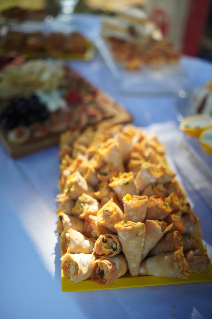 A close-up view of assorted savory appetizers arranged elegantly on an outdoor buffet table.